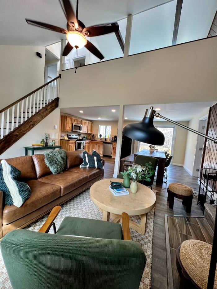 Vaulted living room with the green brick fireplace
