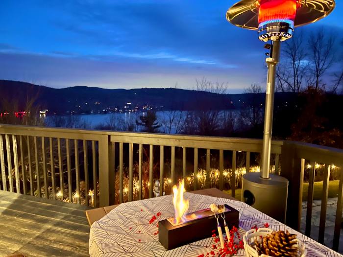 Fire on the deck at dusk overlooking the lake