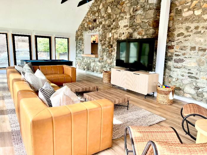 Living room with stone wall and pool table